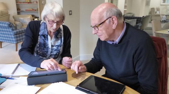 image of two elderly people with a tablet